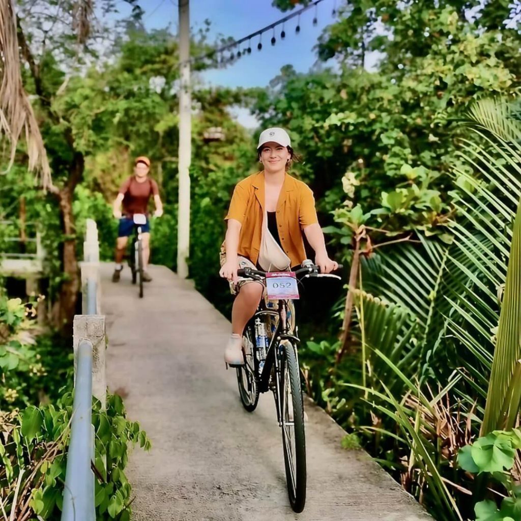 Cyclists riding along raised pathways in Bang Krachao