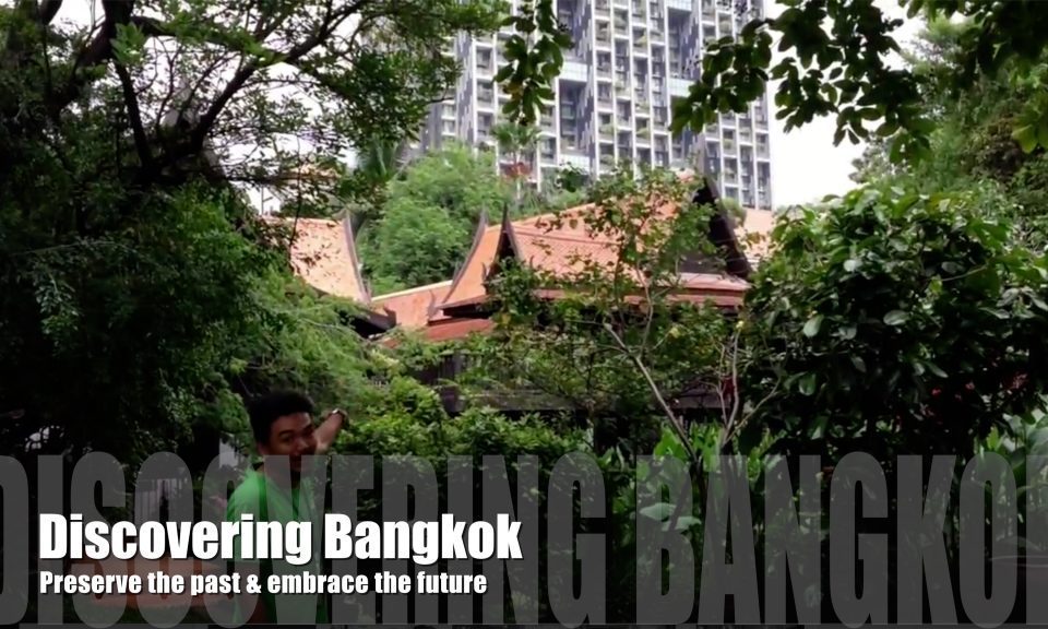 Traditional Thai house and modern city in the background