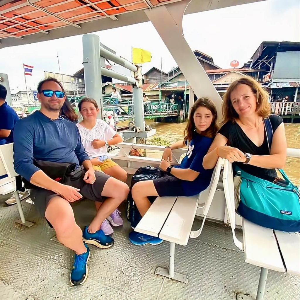 Guests sitting on a local ferry on the Chao Phraya River in Bangkok
