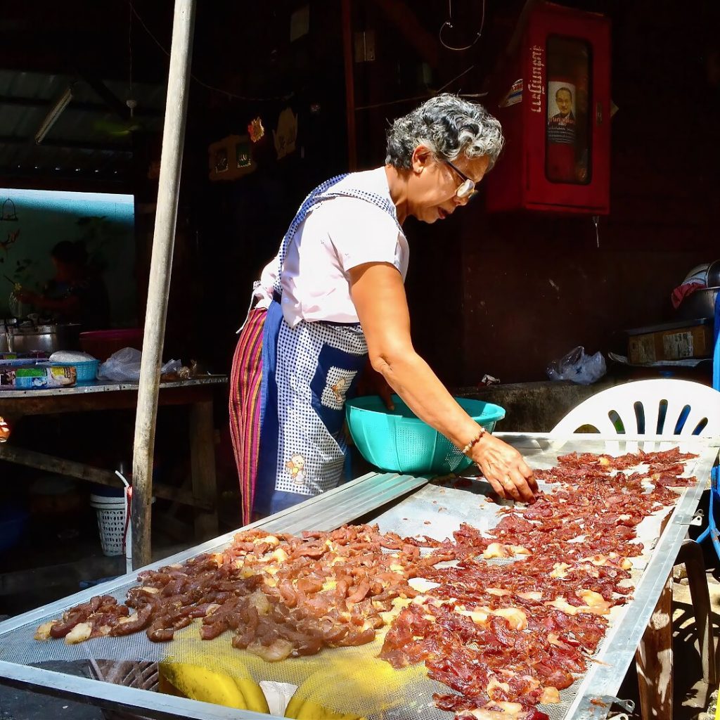 Local resident sun drying meat in Kudeejeen community in Bangkok