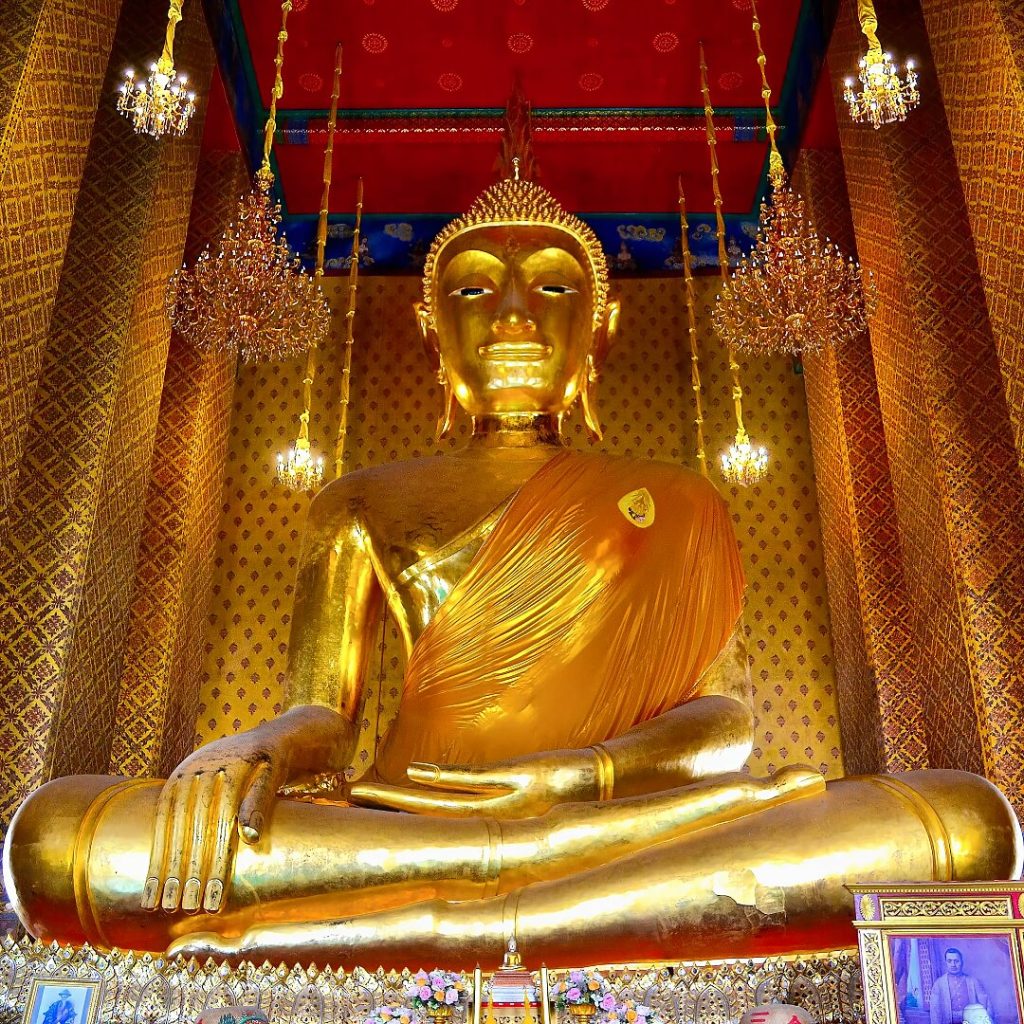 Large seated Buddha statue inside Wat Kalayanamit temple in Bangkok