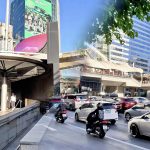 Cycling from Silom MRT to Chong Nonsi Skywalk showing MRT entrance and busy traffic approaching the skywalk in Bangkok