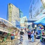 Cycling from Chong Nonsi Skywalk to Saint Louis BTS showing elevated skywalk and busy market street in Bangkok
