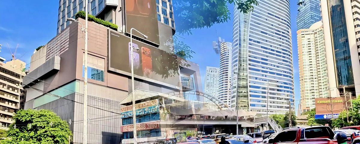 Cycling from Lumphini MRT to Chong Nonsi Skywalk showing Sathorn Road buildings and elevated skywalk with office towers in Bangkok
