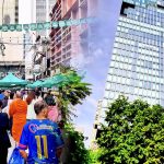 Cycling from Patpong market to Mahanakhon tower showing busy market street and view up the tower in Bangkok