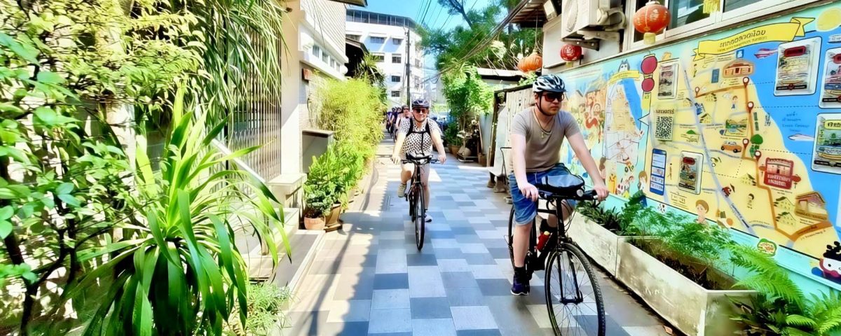 Cyclist riding through a narrow lane in Talat Noi Bangkok