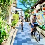Cyclist riding through a narrow lane in Talat Noi Bangkok