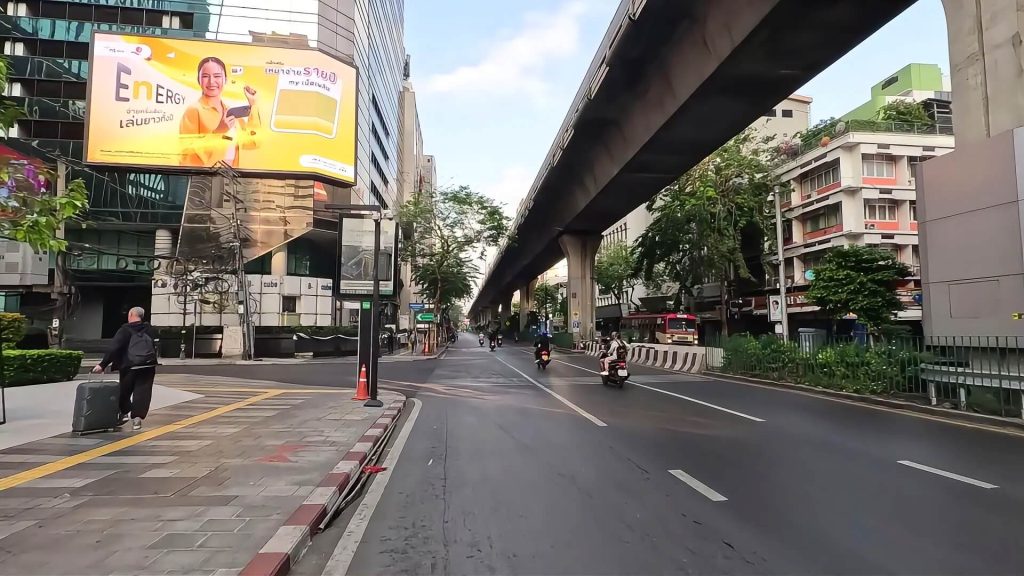 Early morning view of Silom Road in Bangkok with light traffic and office buildings