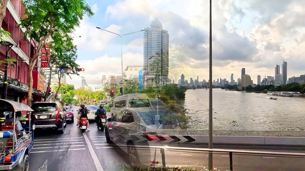 Split view of Silom Road traffic at a red light and the Bangkok skyline from Chao Phraya Sky Park